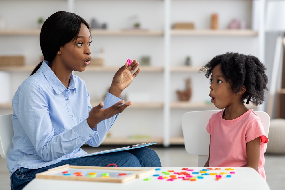 Speech therapist working with child